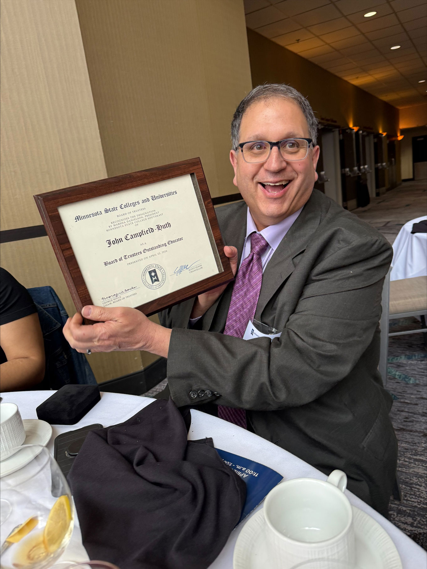 Band instrument repair instructor John Huth displays the Educator of the Year Award.