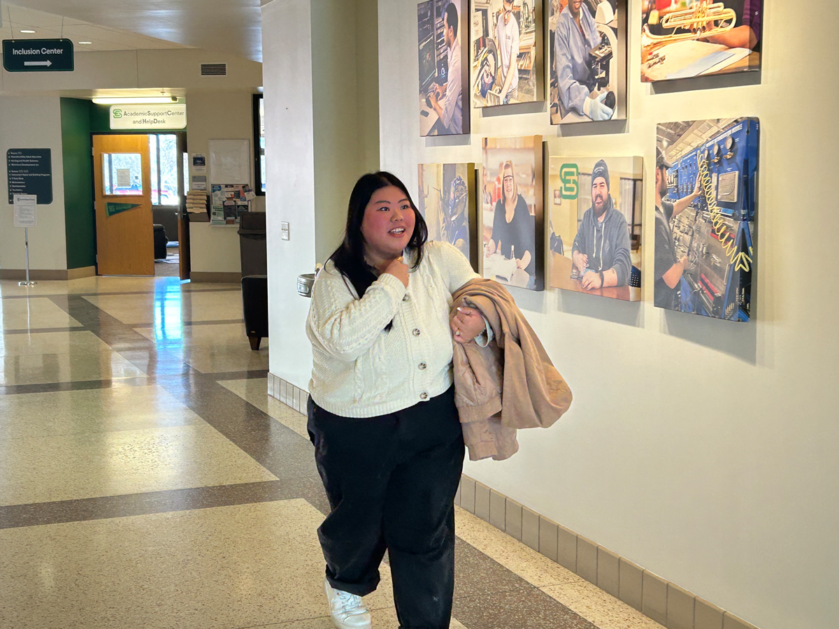 Southeast student Alyvia Xiong walks down hallway on the Red Wing campus.