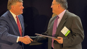 Minnesota State Chancellor Scott Olson (left) shakes hands with Southeast Band Instrument Repair instructor John Huth, after Huth was honored as Educator of the Year.