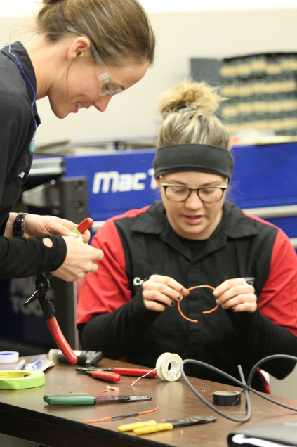 Instructor and student working on wiring