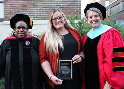 Michelle Larson poses with award alongside Marsha Danielson and third woman, unidentified
